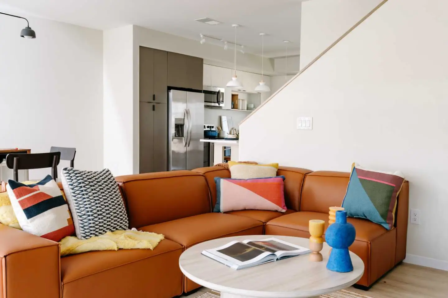 orange couch with a coffee table in front at The Pier