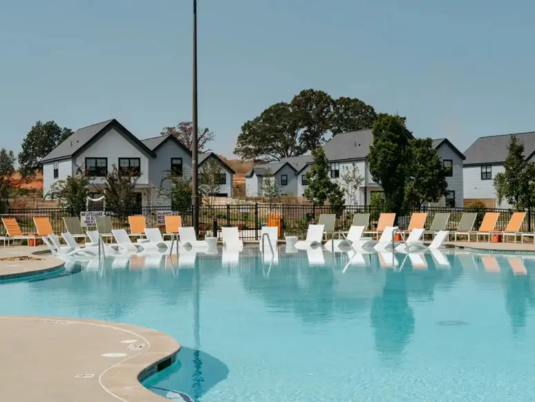 community pool surrounded by lounge chairs
