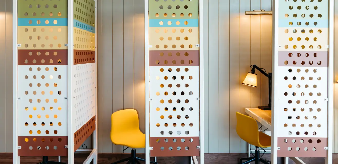 Cubicles with chairs, desks, and lamp