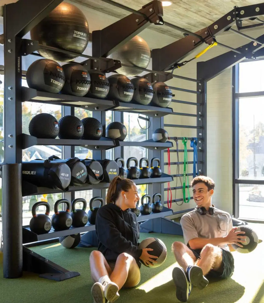 two residents work out in the gym